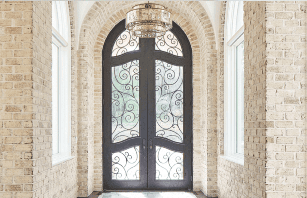 Ornate front door with glass and scrollwork.