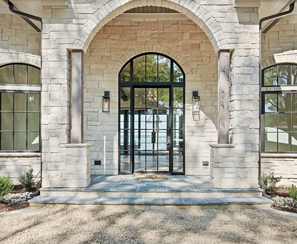 Large contemporary front door with sidelights and transom.