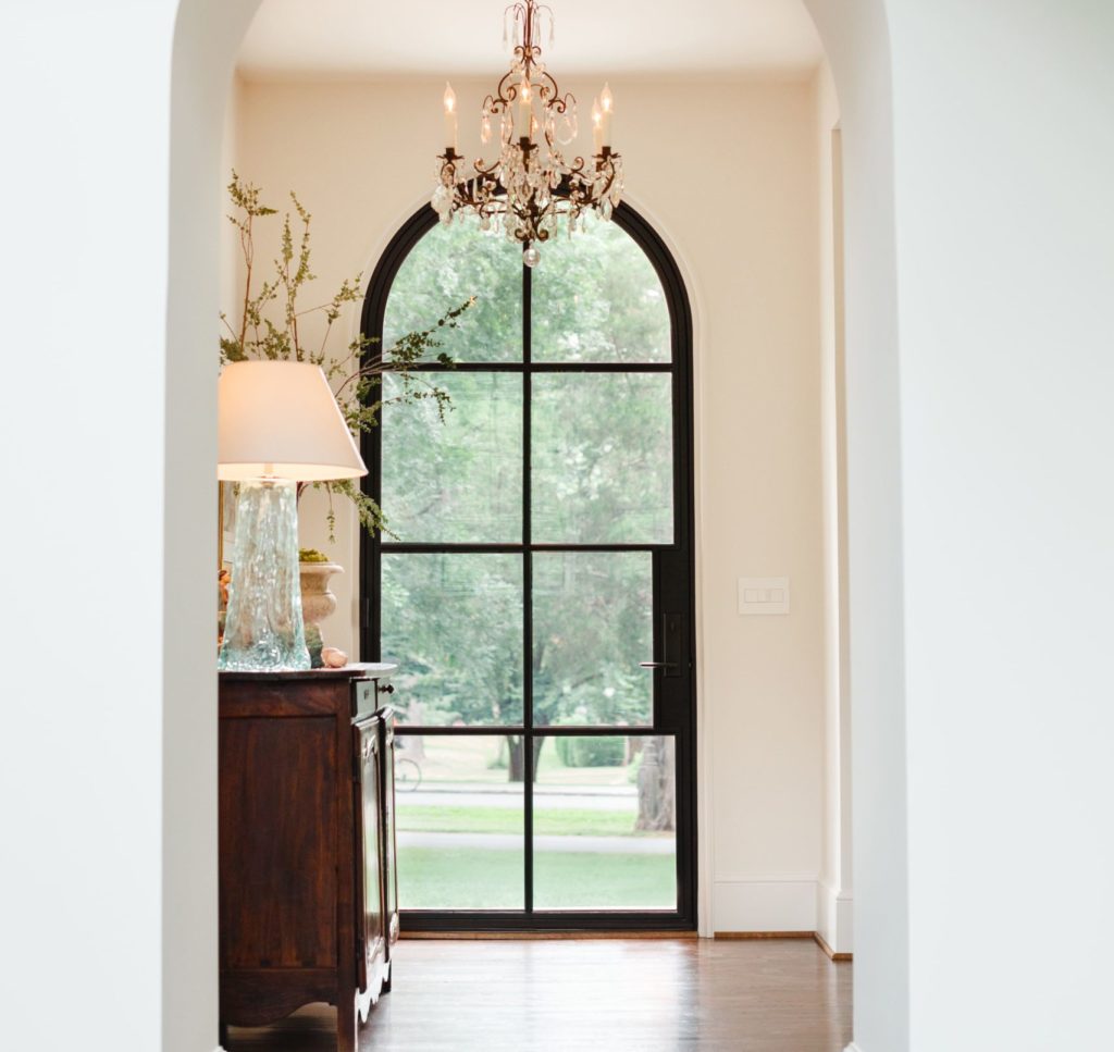 Modern front door with glass that is in a rounded arch.