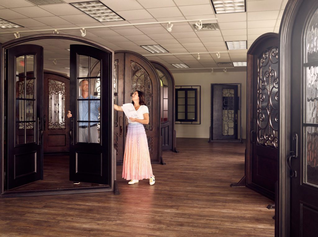 A couple visits Clark Hall's design studio to see custom iron door options.