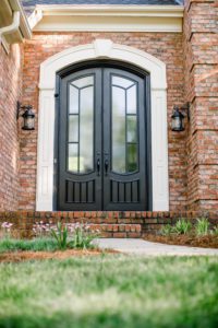 A traditional double iron door entryway featuring a charcoal finish.