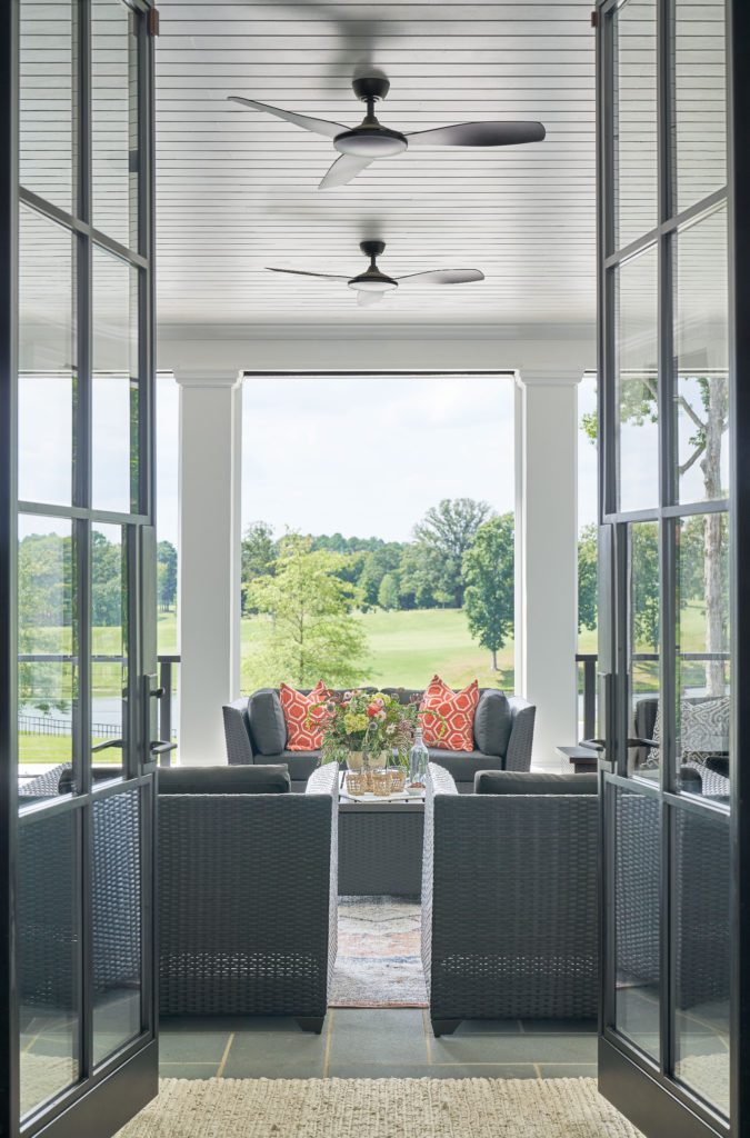 Tall custom doors opening up to back patio on golf course.