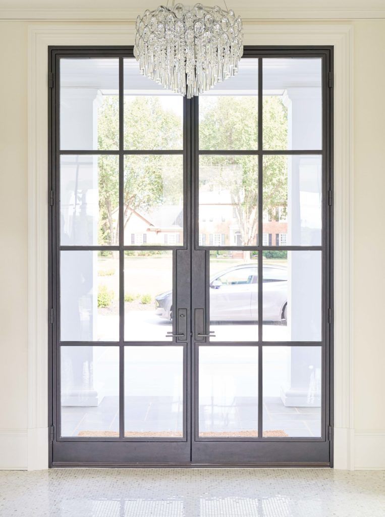 Interior view of modern door with chandelier.