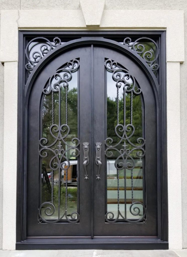 Ornate door entrance with intricate scrollwork and clear glass.