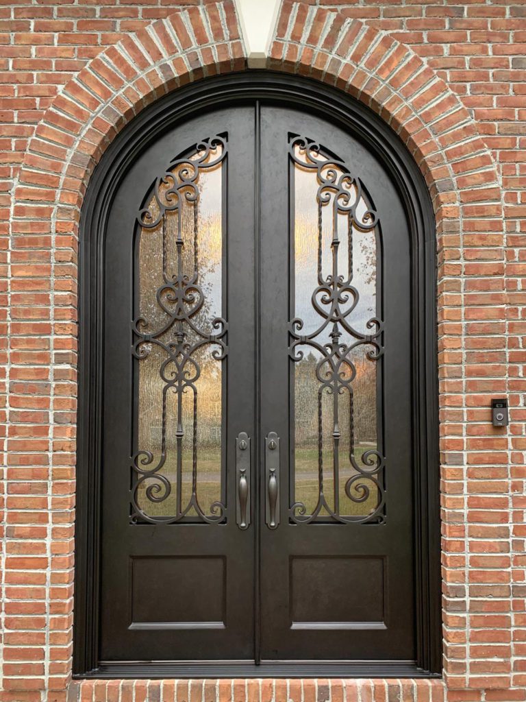 Dark charcoal double door entrance with brick exterior