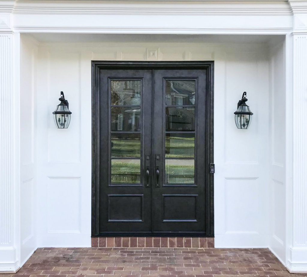 Traditional double doors with brick walkway.
