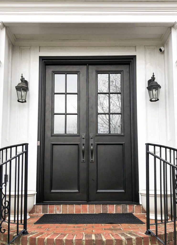 Traditional doors with brick and white exterior.