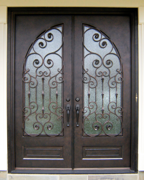 Ornate door with textured glass and dark finish.