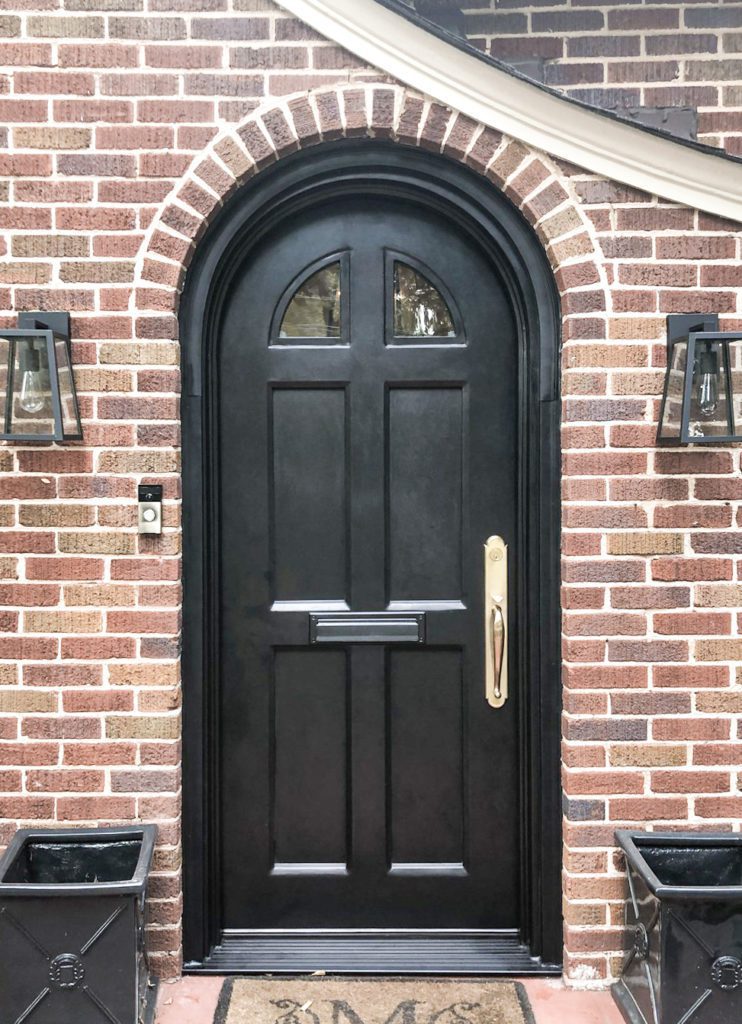 Rounded traditional door with dark finish.