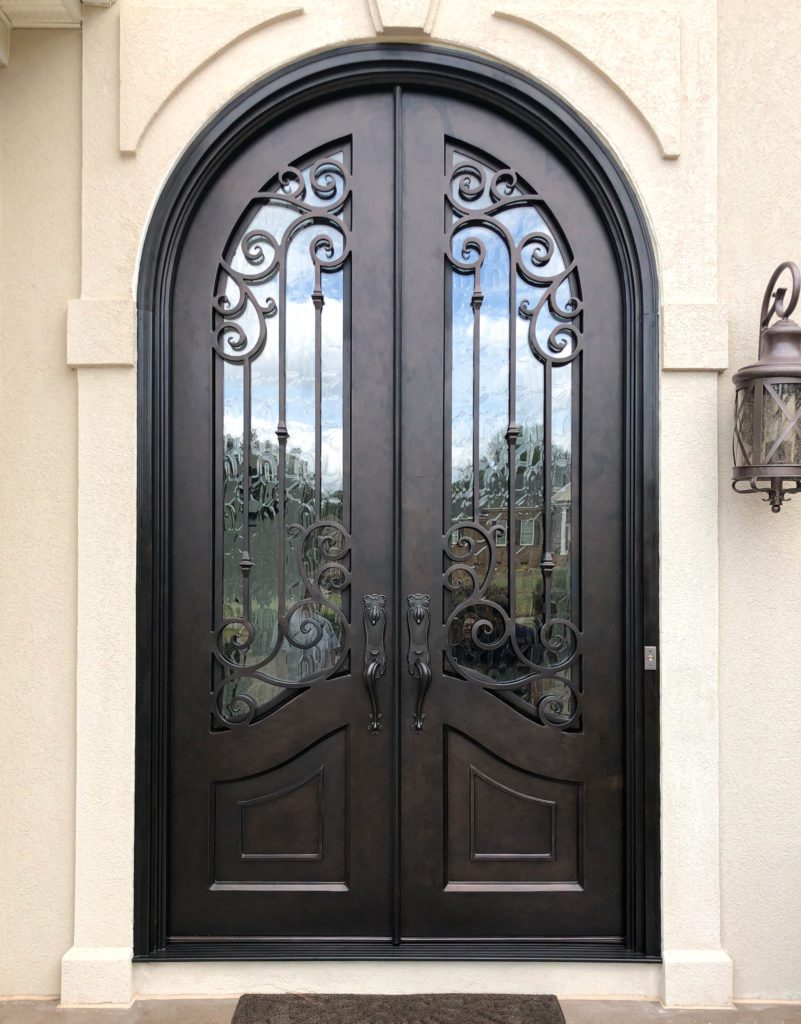 Large double door entryway with ornate scrollwork.