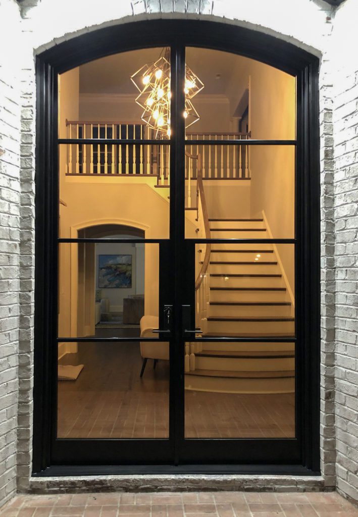Arched Charcoal entryway with light fixture.