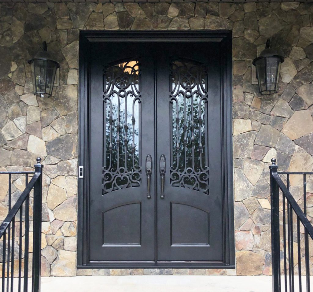 Entrance to a ornate door with traditional door handles.