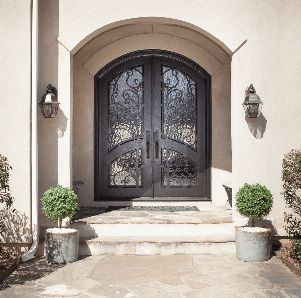 Ornate door with segmented arch and textured glass.