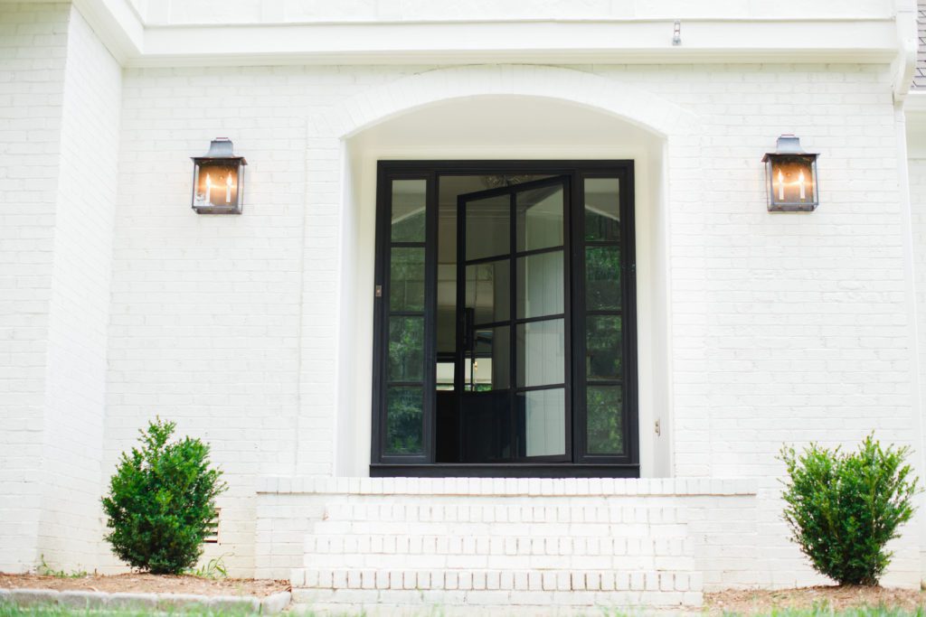 A modern iron door with two sidelights.