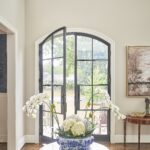 A bright foyer with modern front doors.