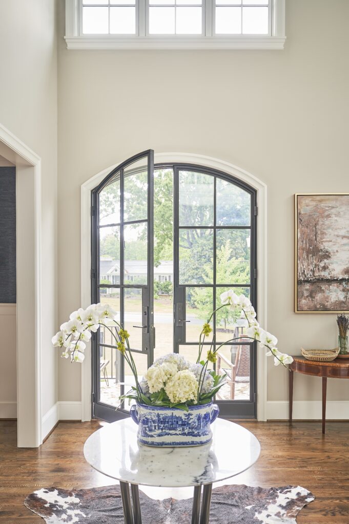 A bright foyer with modern front doors.