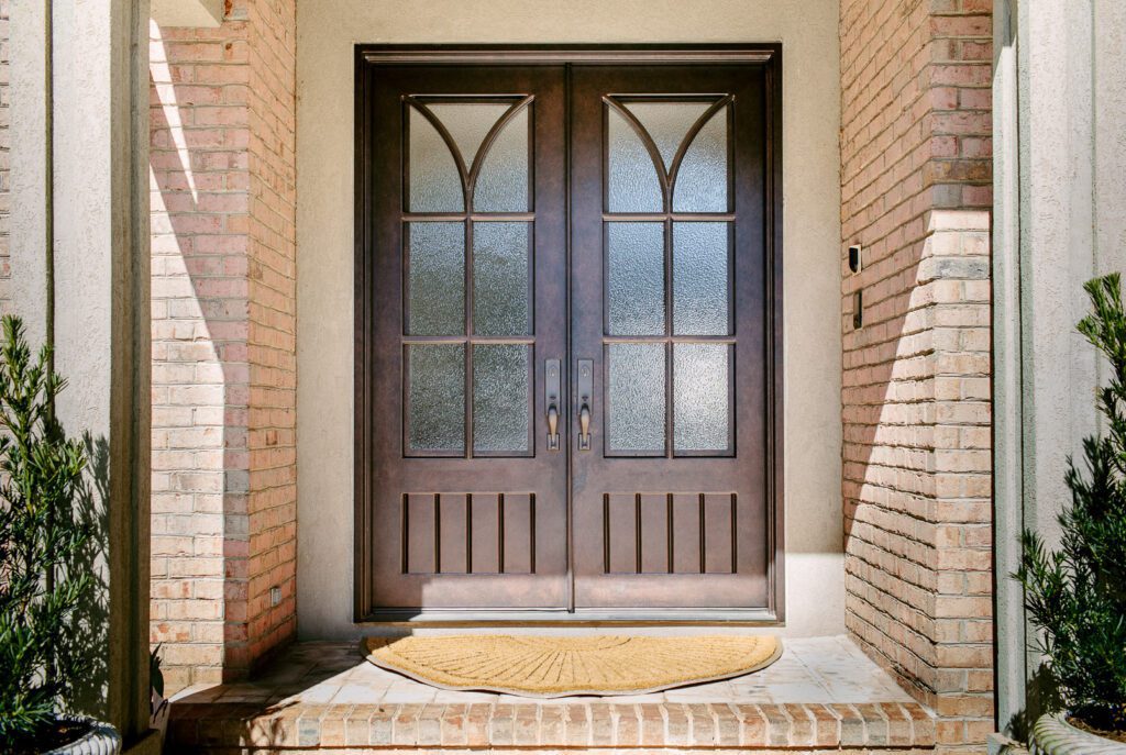 A traditional style door on a brown brick home