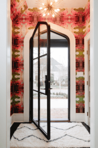 Pointed silhouette modern front door with whimsical chandelier