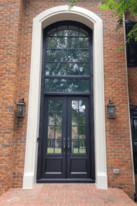 Traditional iron door with transom in brick layered house