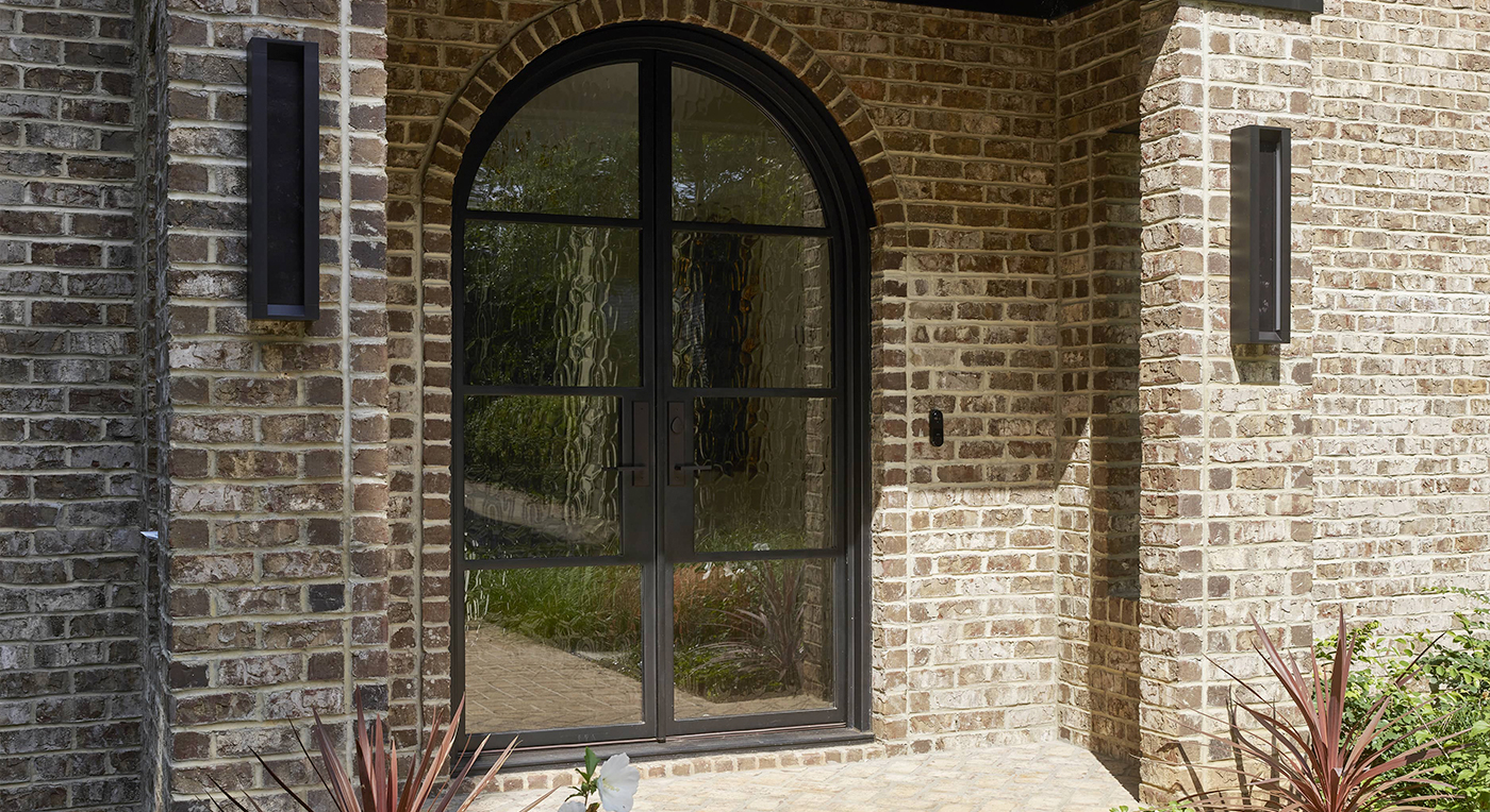 Modern iron door with textured Flemish glass and burnt copper finish