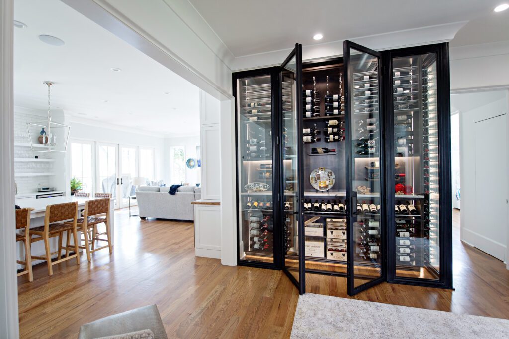 Open wine cellar glass door filled with wines