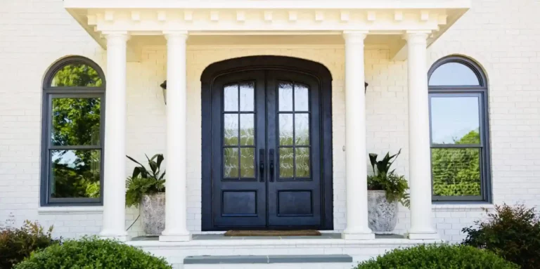 Modern entry doors in traditional house with pillars